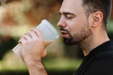 A man is having a protein shake to lose weight and gain muscles